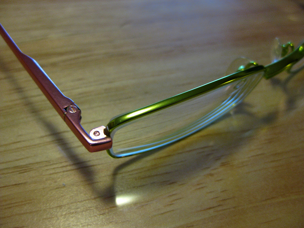 How can you remove scratches from eyeglasses?