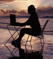 At the beach on a laptop At the beach on a laptop