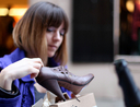 woman holding shoe
