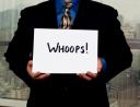 Businessman with a "whoops" sign