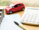 Coins stack in columns on saving book and car