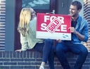 Couple picking the best home offer to sell their house