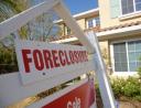 Foreclosure sign in front of a house