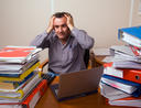 Man with too much paperwork