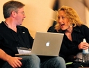 Talking man and woman with laptop