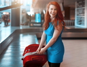 Tourist woman picking up luggage