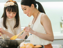 Woman using her electric wok to cook dinner