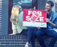 Couple picking the best home offer to sell their house