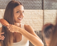 Woman using best stay-at-home haircare products